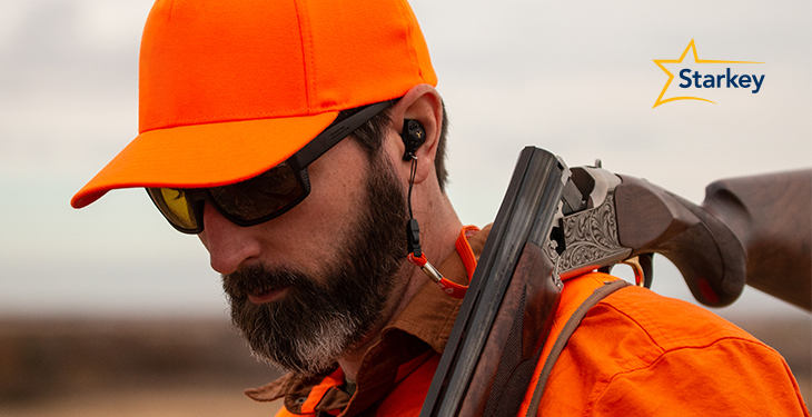 Image of hunter dressed in blaze orange and wearing SoundGear Phantom hearing protection